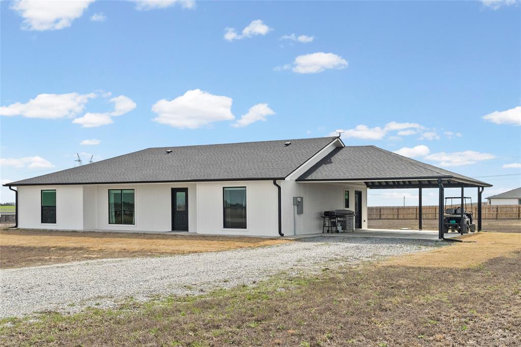170 Private Road Brookston, TX 75421 - Photo 2 of 33 a front view of a house with a yard and garage