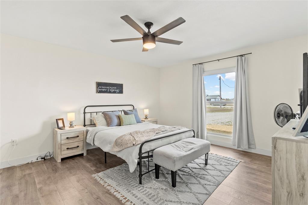 170 Private Road Brookston, TX 75421 - Photo 24 of 33 a bedroom with a bed and a chandelier