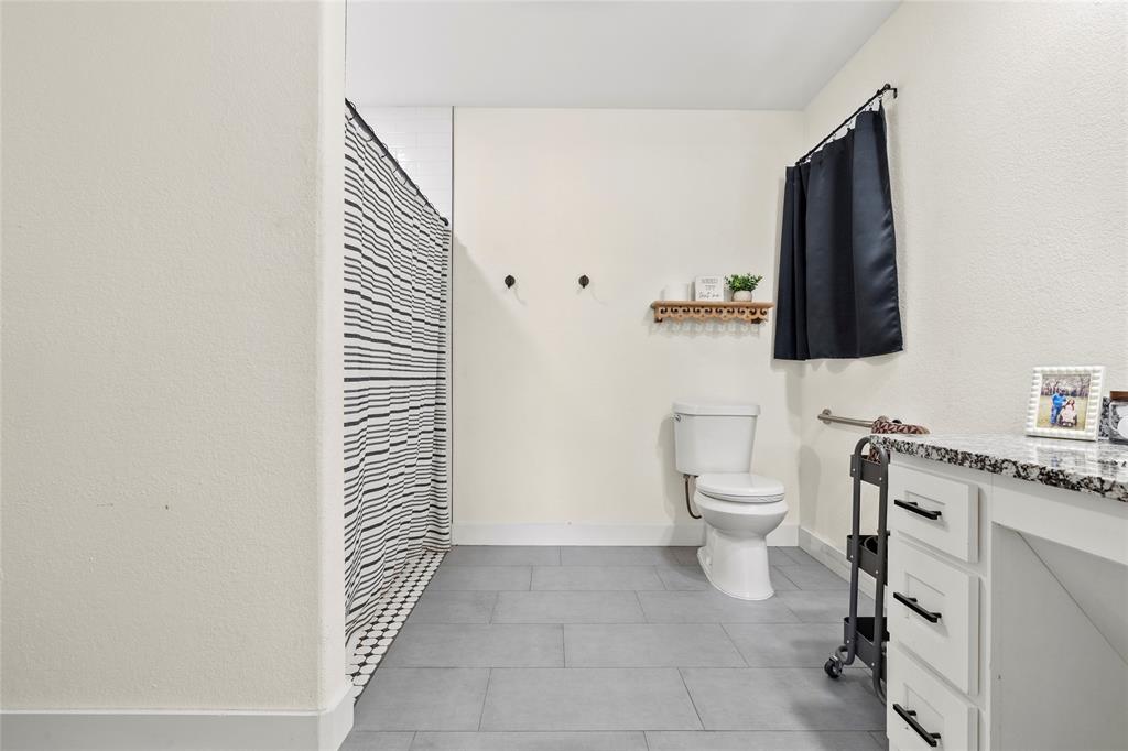 170 Private Road Brookston, TX 75421 - Photo 25 of 33 a bathroom with a toilet a sink and mirror