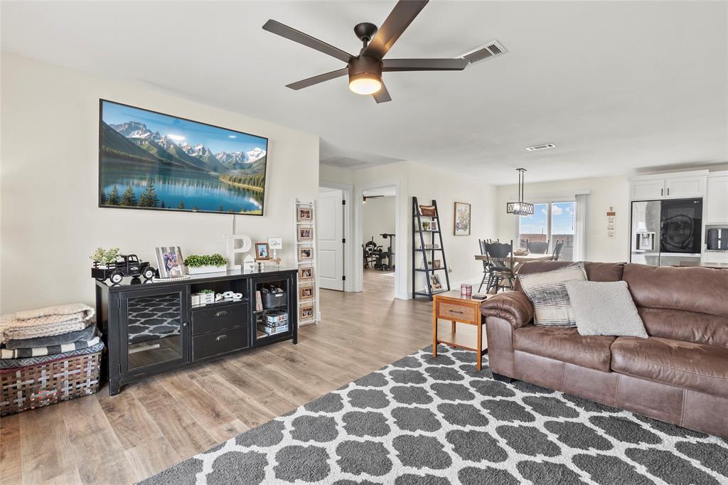 170 Private Road Brookston, TX 75421 - Photo 6 of 33 a living room with couches and kitchen view with wooden floor