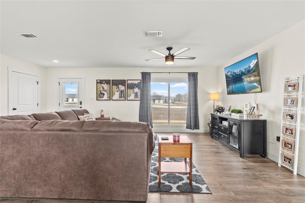 170 Private Road Brookston, TX 75421 - Photo 9 of 33 a living room with furniture a flat screen tv and a fireplace