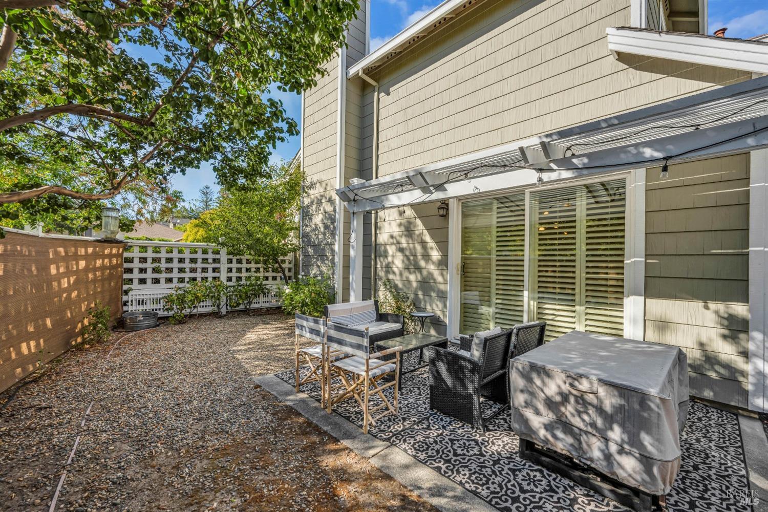 921 Chiles Avenue St. Helena, CA 94574 - Photo 18 of 20 a view of a patio with a table chairs and wooden fence