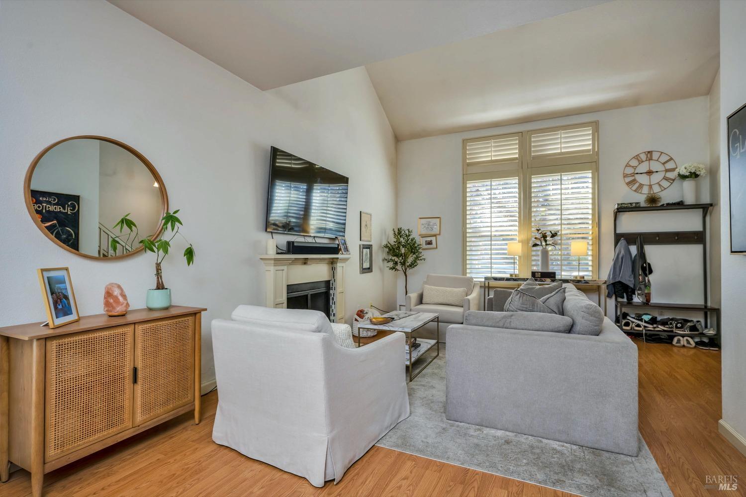 921 Chiles Avenue St. Helena, CA 94574 - Photo 5 of 20 a living room with furniture a fireplace and a flat screen tv