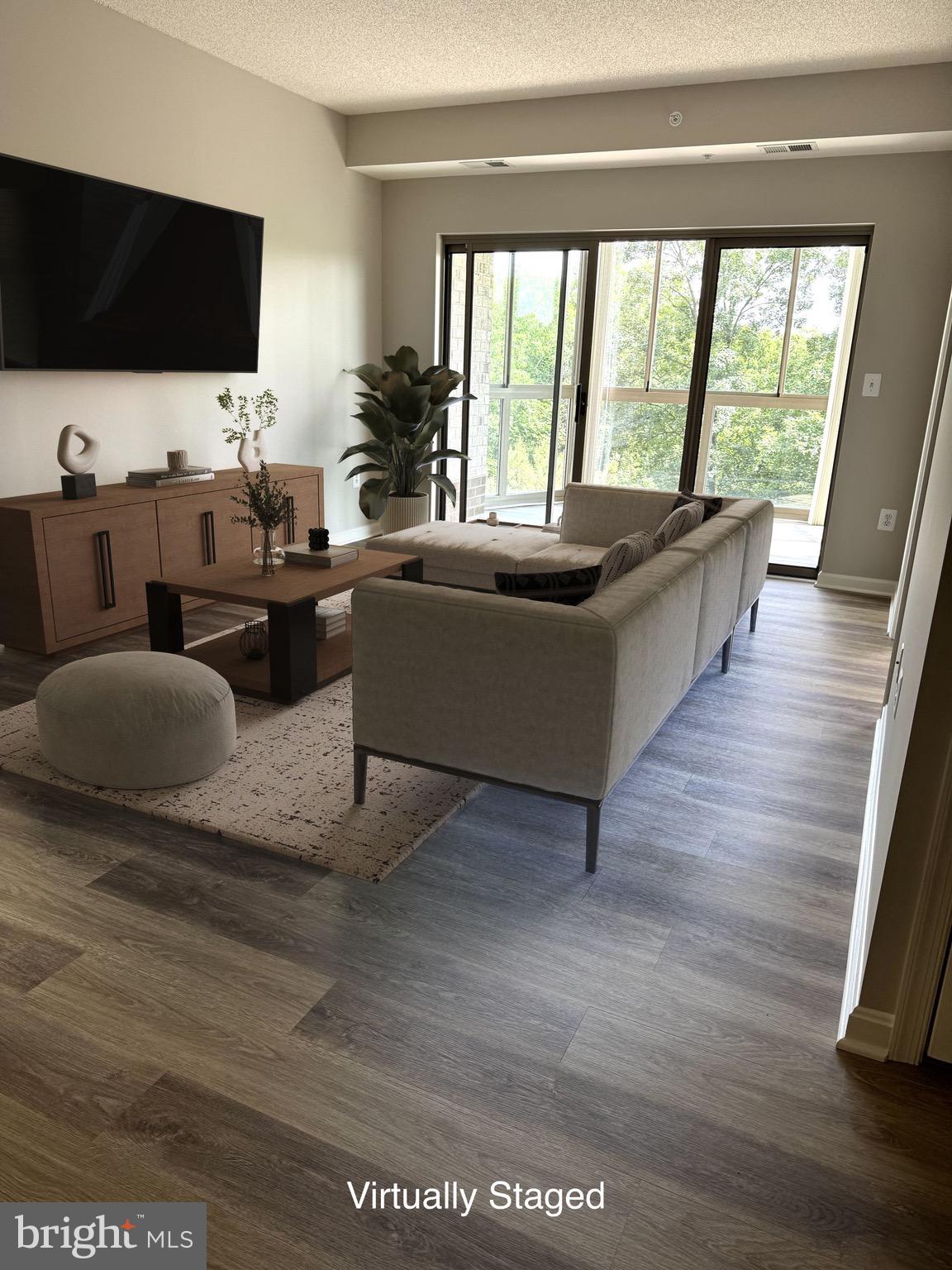 19375 Cypress Ridge Terrace, Unit 404 Leesburg, VA 20176 - Photo 4 of 29 Living room viewing onto glass enclosed sunroom