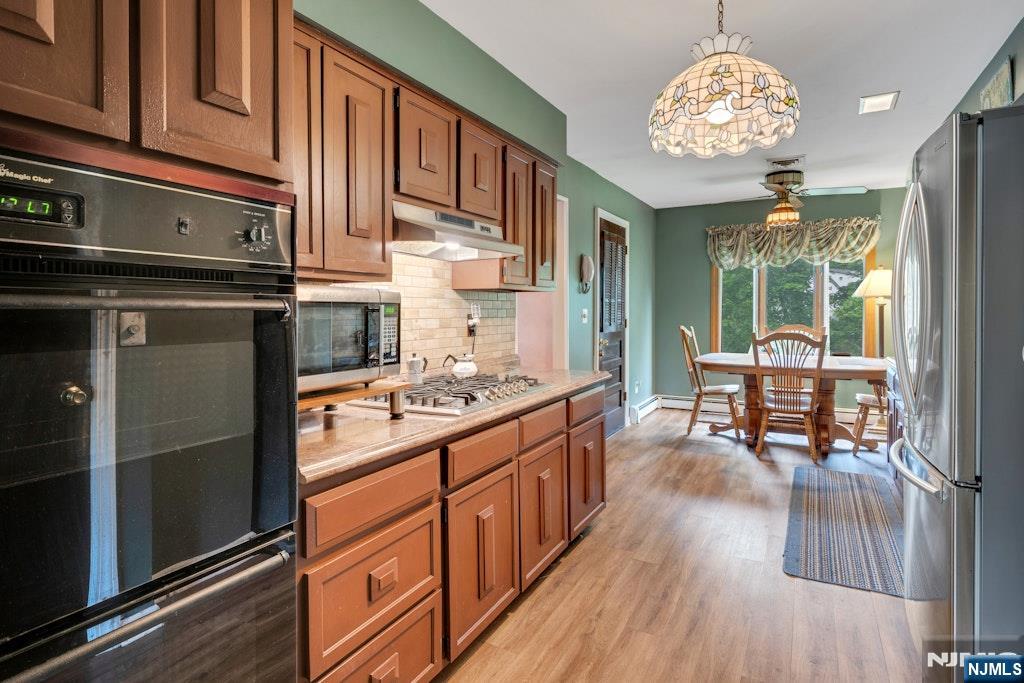 185 Ratzer Road Wayne, NJ 07470 - Photo 15 of 36 a kitchen with stainless steel appliances granite countertop a stove oven and a refrigerator with cabinets