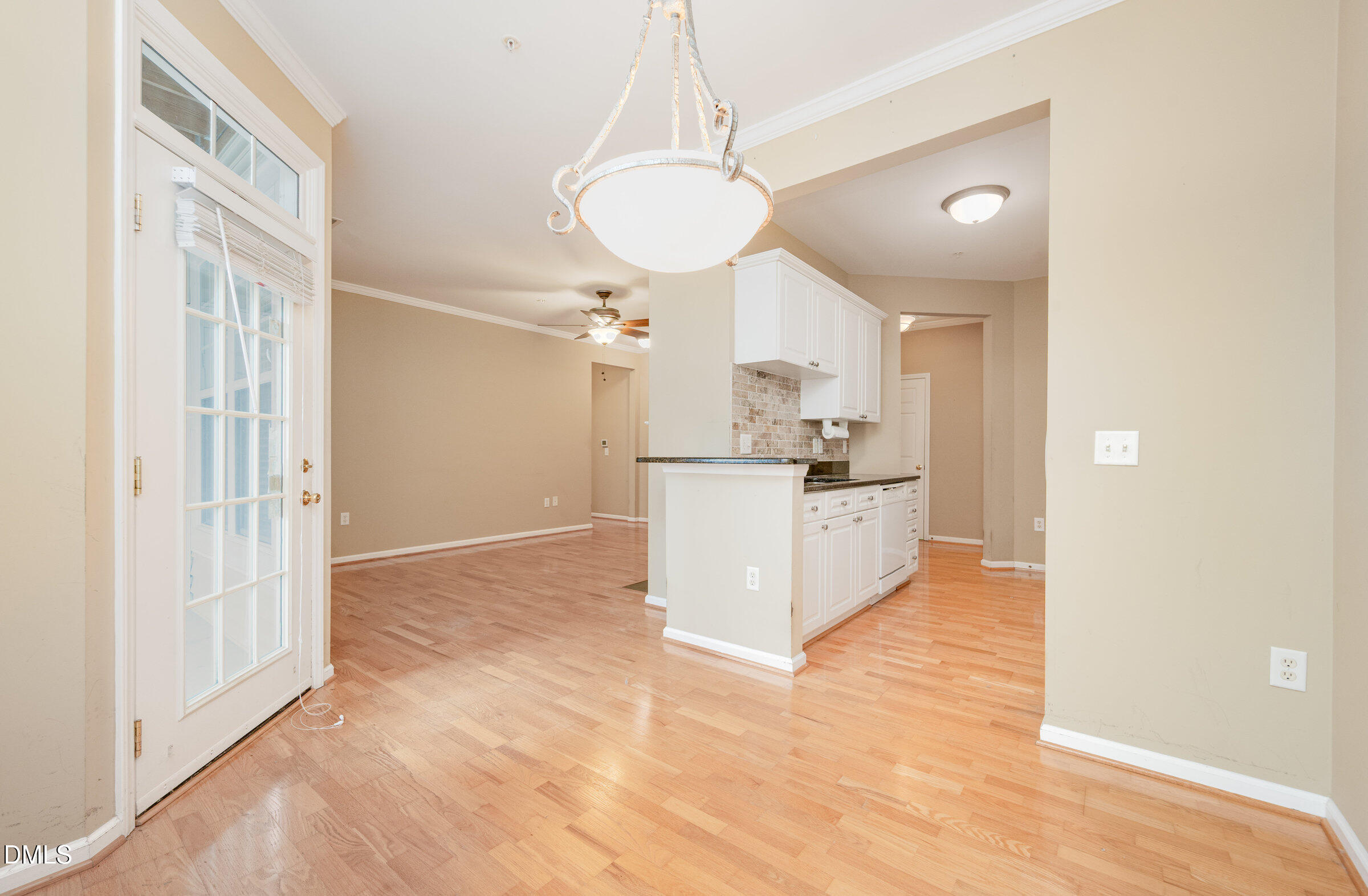 8041 Allyns Landing Way, Unit 101 Raleigh, NC 27615 - Photo 12 of 32 a view of a kitchen with wooden floor and a refrigerator