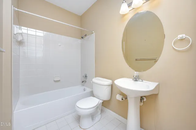 a bathroom with a toilet a sink and a mirror