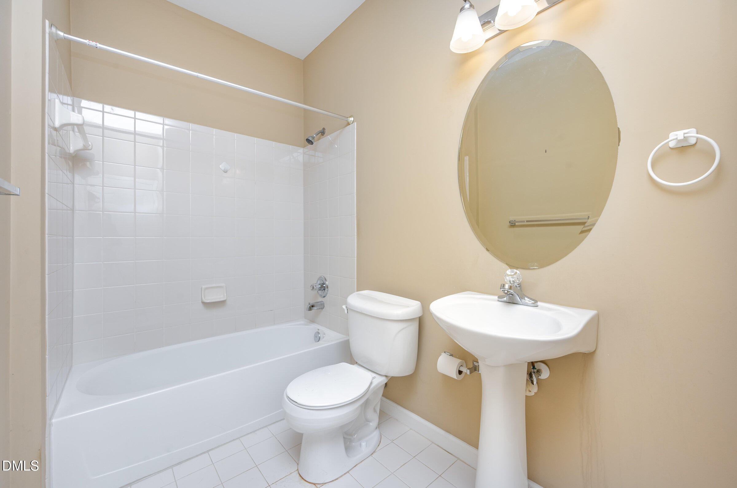 8041 Allyns Landing Way, Unit 101 Raleigh, NC 27615 - Photo 19 of 32 a bathroom with a toilet a sink and a mirror