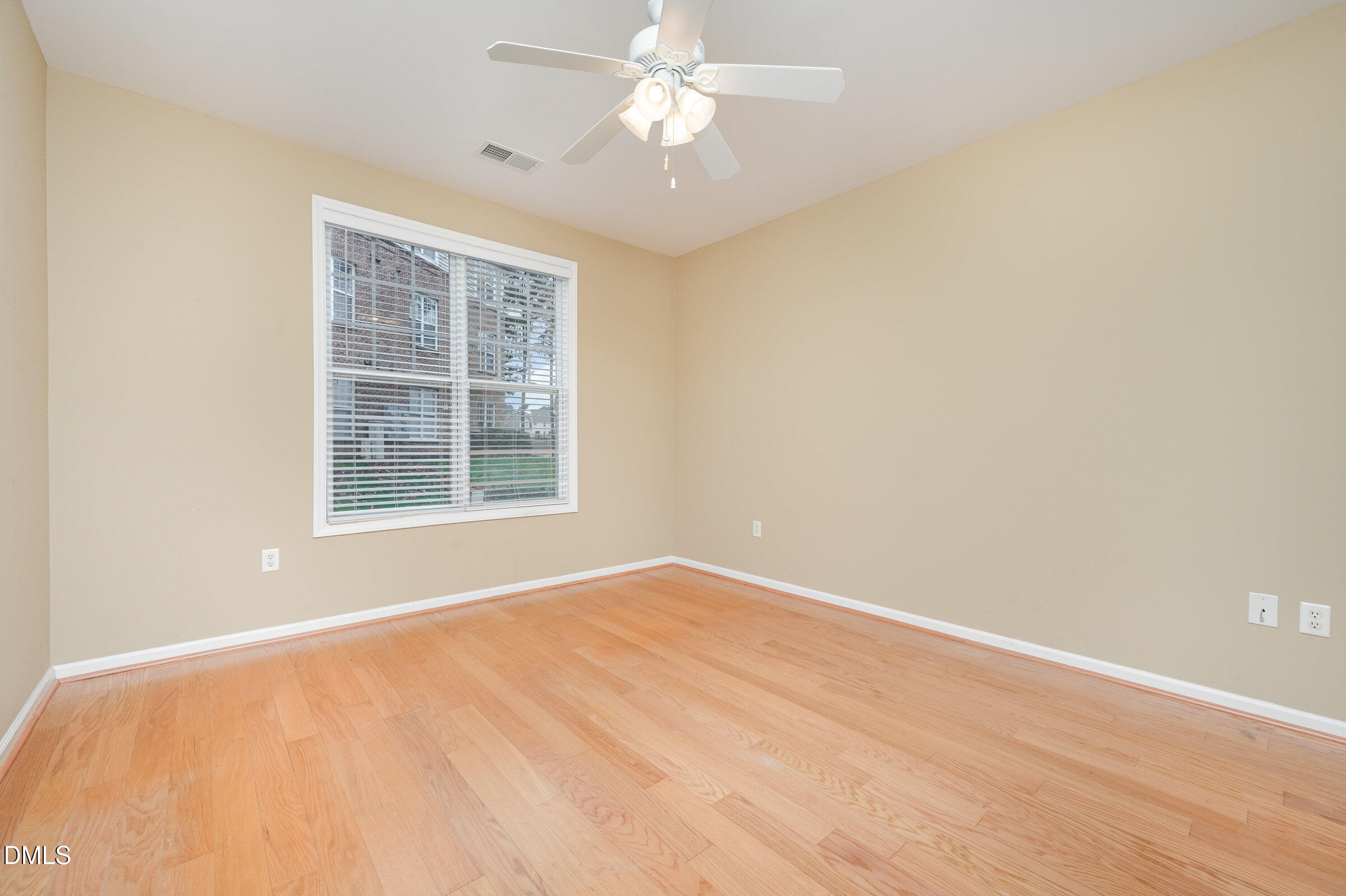 8041 Allyns Landing Way, Unit 101 Raleigh, NC 27615 - Photo 20 of 32 an empty room with a window and a ceiling fan