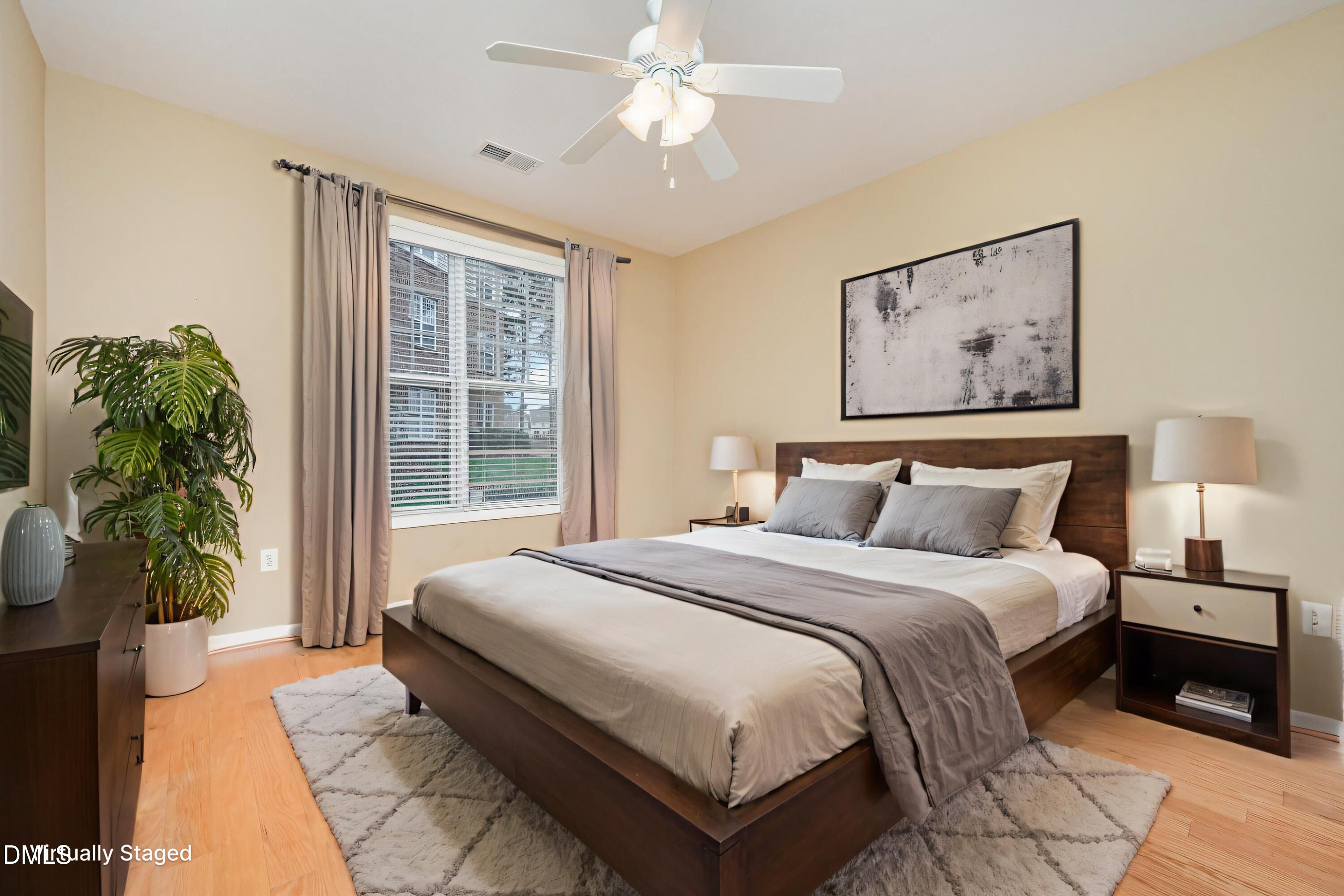 8041 Allyns Landing Way, Unit 101 Raleigh, NC 27615 - Photo 21 of 32 a spacious bedroom with a bed and a large window