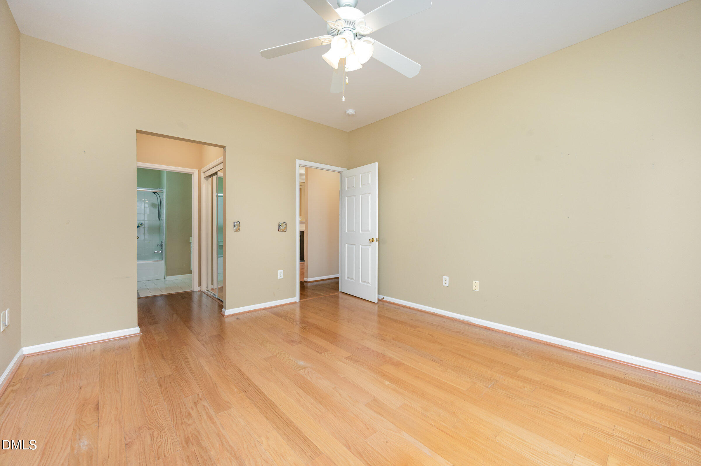 8041 Allyns Landing Way, Unit 101 Raleigh, NC 27615 - Photo 22 of 32 an empty room with wooden floor and a ceiling fan