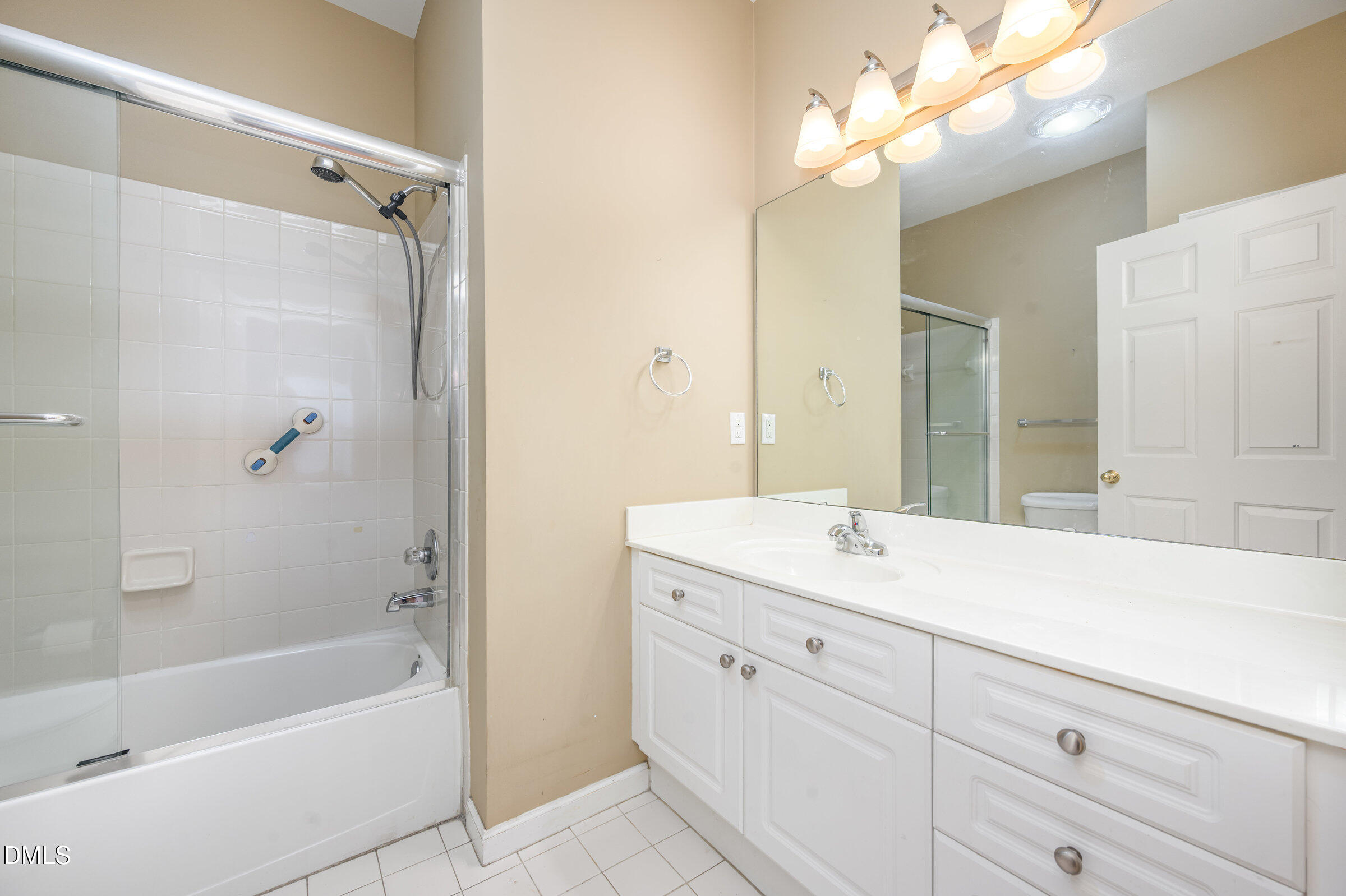 8041 Allyns Landing Way, Unit 101 Raleigh, NC 27615 - Photo 23 of 32 a bathroom with a sink double vanity mirror and bathtub