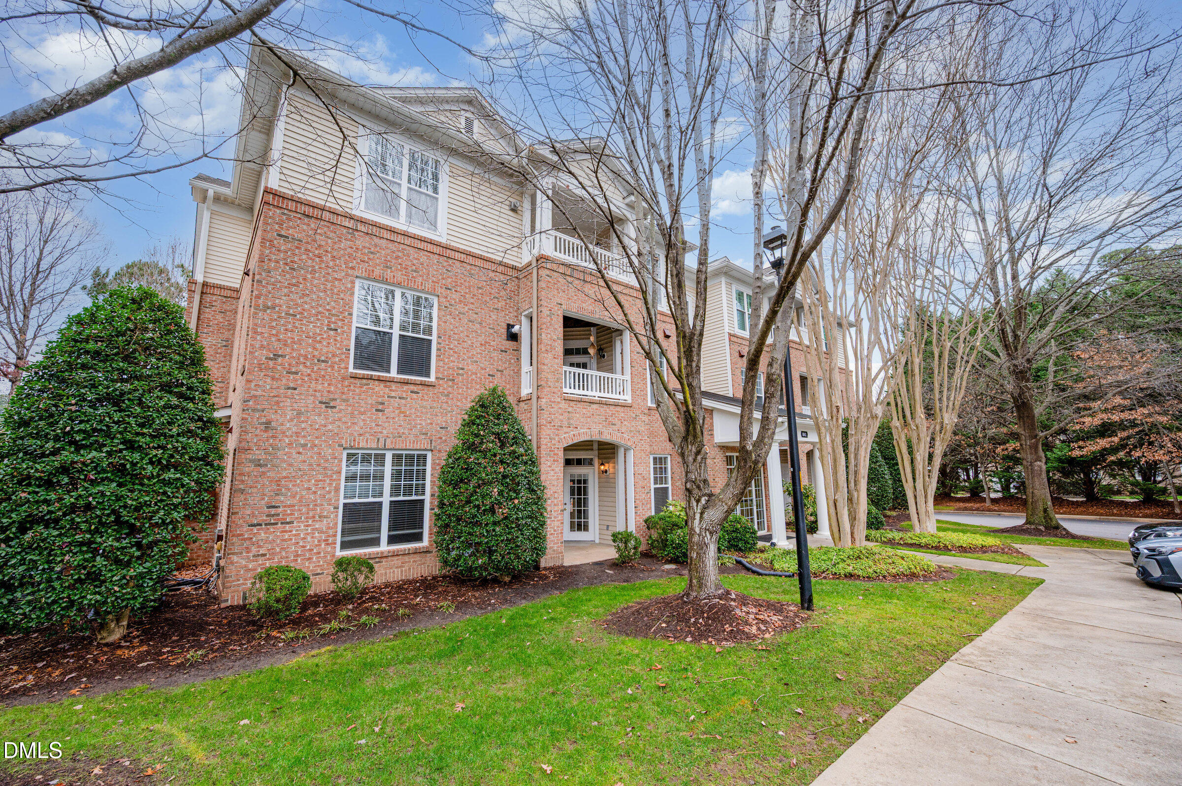 8041 Allyns Landing Way, Unit 101 Raleigh, NC 27615 - Photo 2 of 32 a front view of a house with a garden and tree