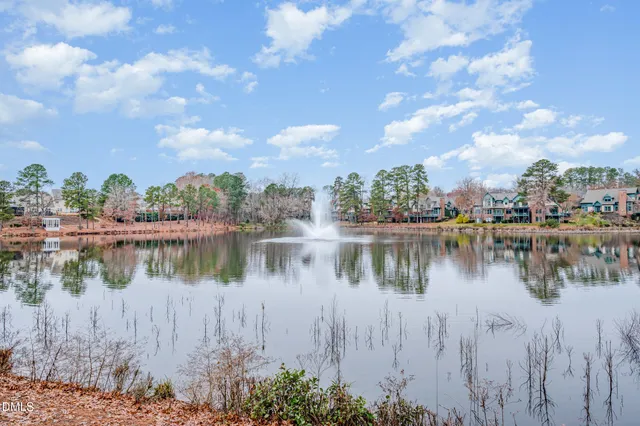 a view of a lake with houses in the background