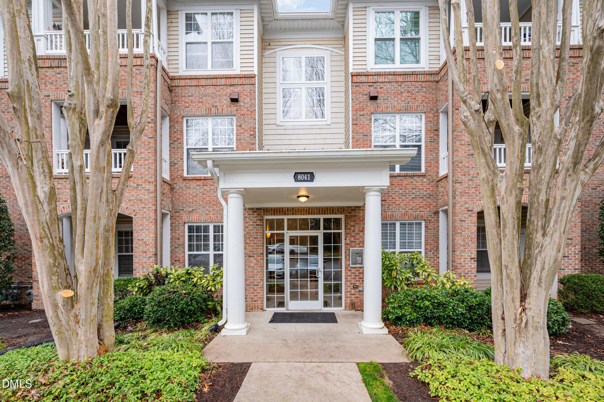 8041 Allyns Landing Way, Unit 101 Raleigh, NC 27615 - Photo 4 of 32 a front view of a house with a garden