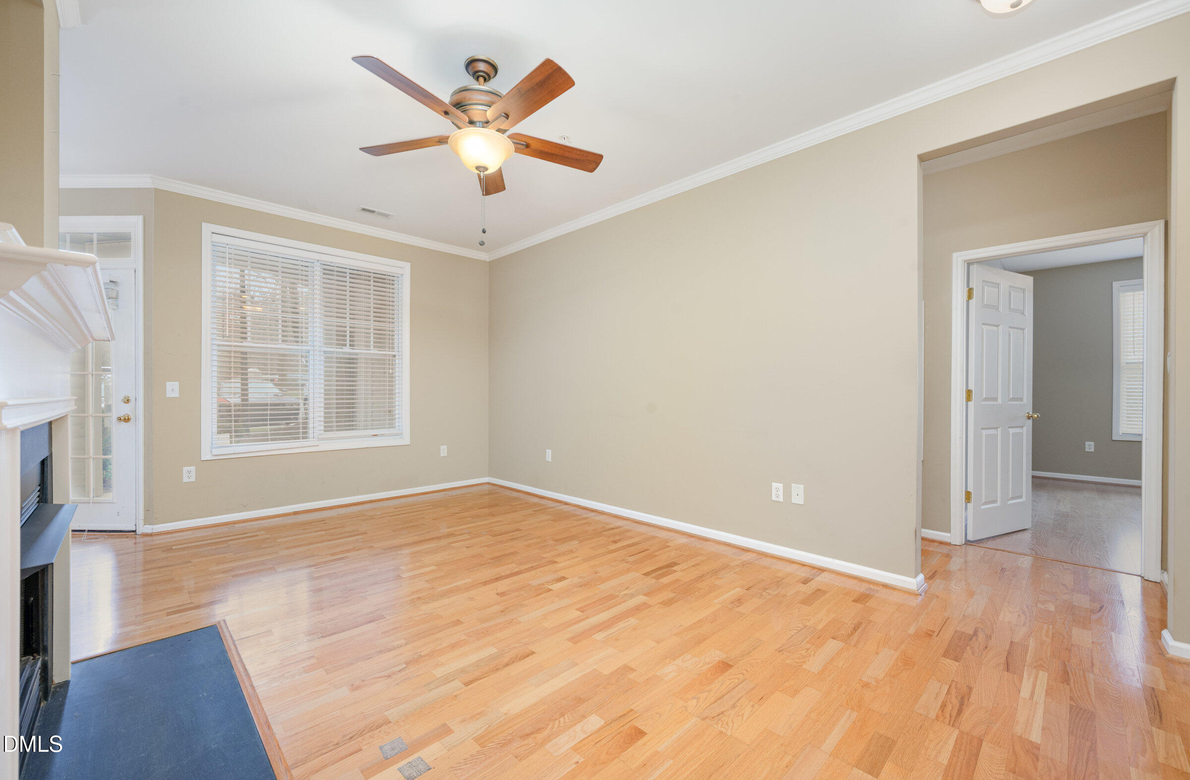 8041 Allyns Landing Way, Unit 101 Raleigh, NC 27615 - Photo 6 of 32 an empty room with wooden floor and windows