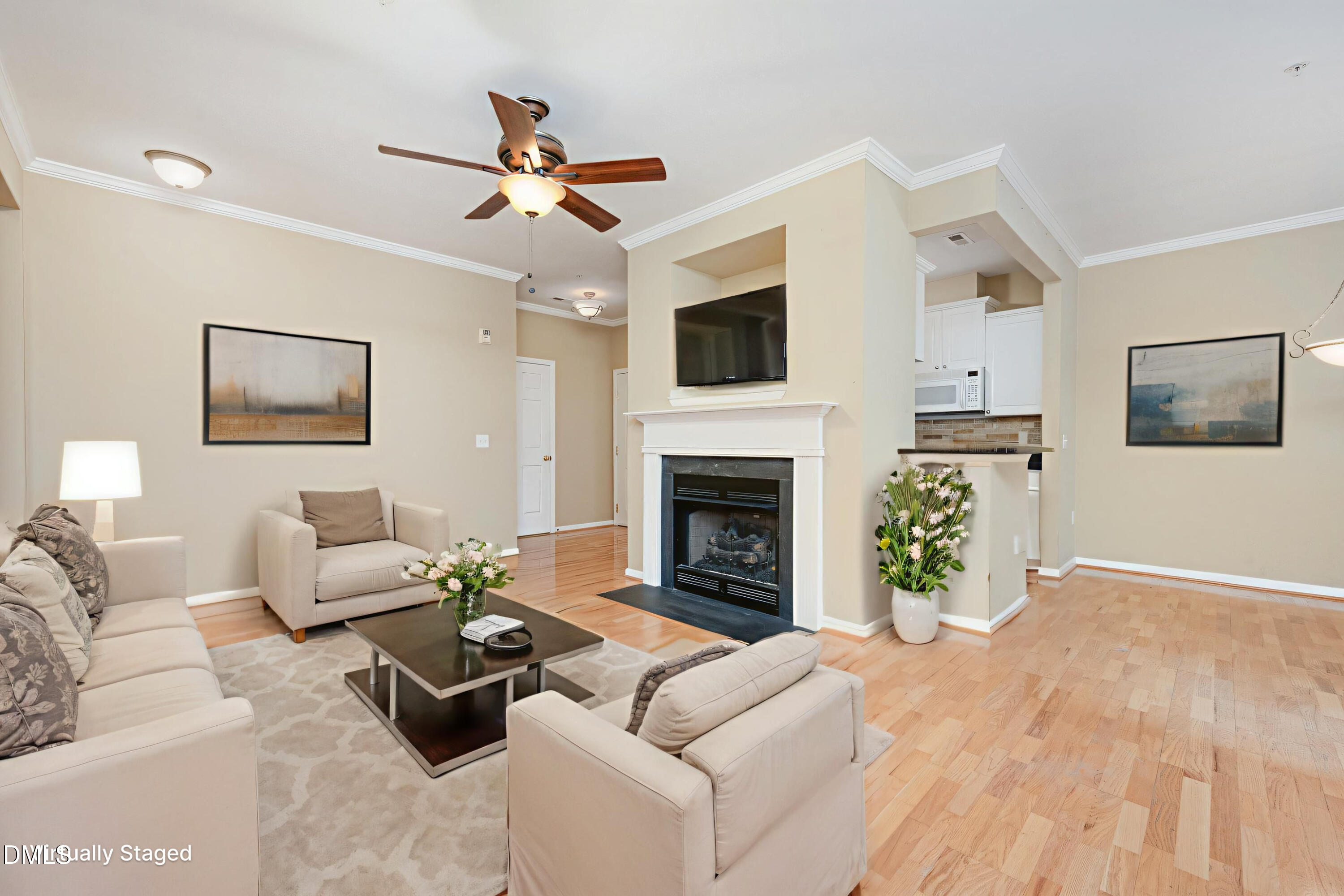 8041 Allyns Landing Way, Unit 101 Raleigh, NC 27615 - Photo 9 of 32 a living room with furniture a flat screen tv and a fireplace