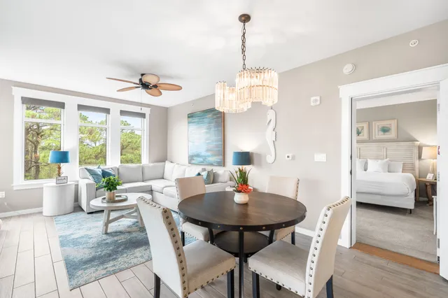 a living room with furniture and a large window with balcony view