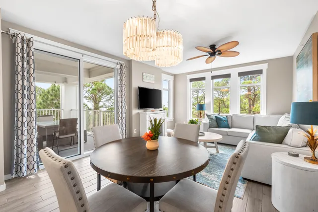 a view of a dining room with furniture a chandelier and wooden floor