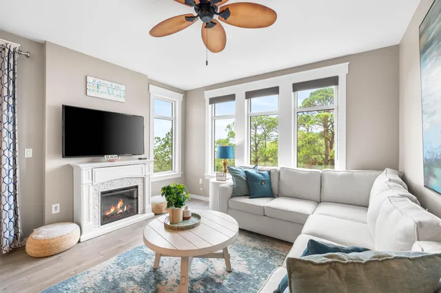 a living room with furniture a flat screen tv and a fireplace