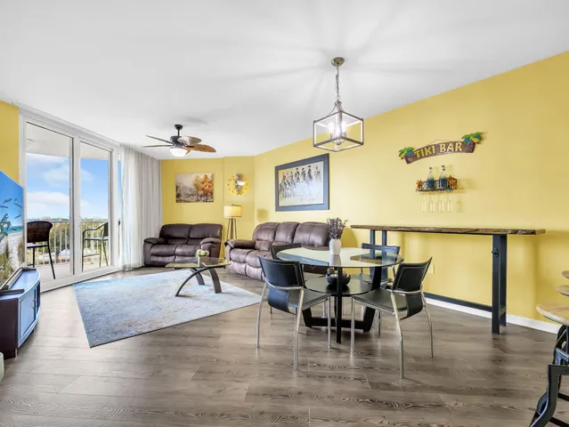a living room with furniture a window and stainless steel appliances