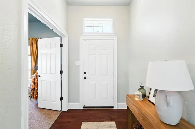 a living room with furniture a rug and a window