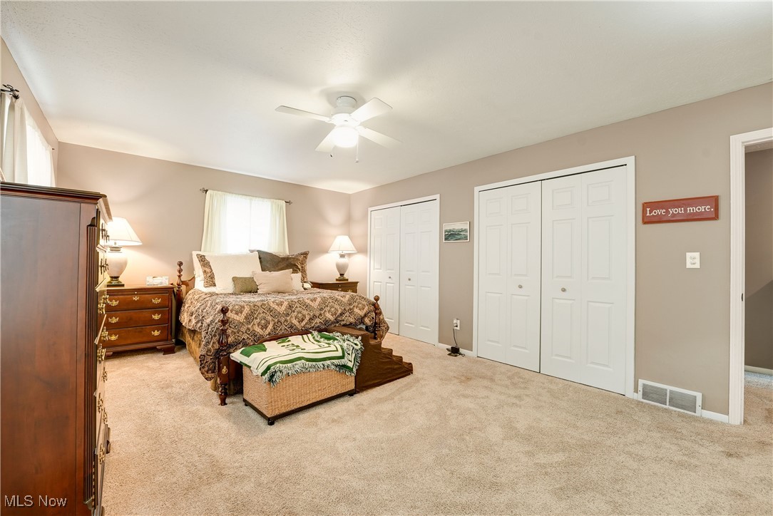 1862 Middleton Road Hudson, OH 44236 - Photo 13 of 32 Bedroom with carpet floors, two closets, and a ceiling fan