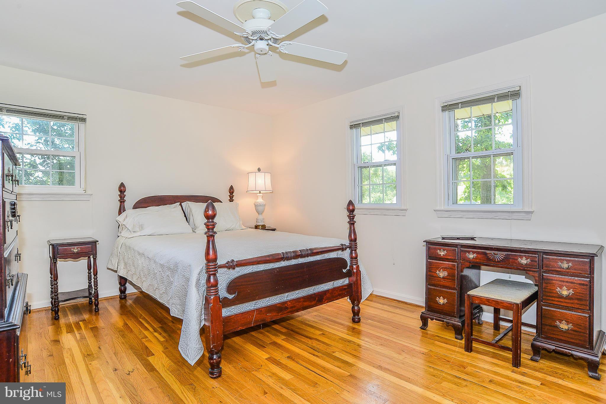 6000 Filbert Court Springfield, VA 22152 - Photo 14 of 21 a bedroom with a bed and wooden floor