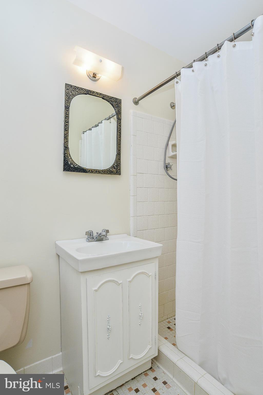 6000 Filbert Court Springfield, VA 22152 - Photo 16 of 21 a bathroom with a sink a toilet and a mirror