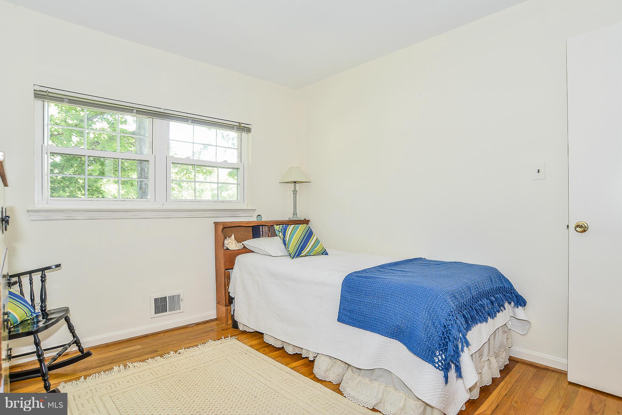 6000 Filbert Court Springfield, VA 22152 - Photo 18 of 21 a bedroom with a bed and wooden floor