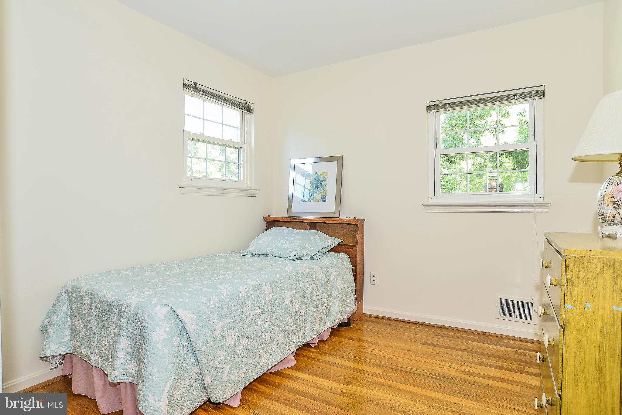 6000 Filbert Court Springfield, VA 22152 - Photo 19 of 21 a bedroom with a bed and wooden floor
