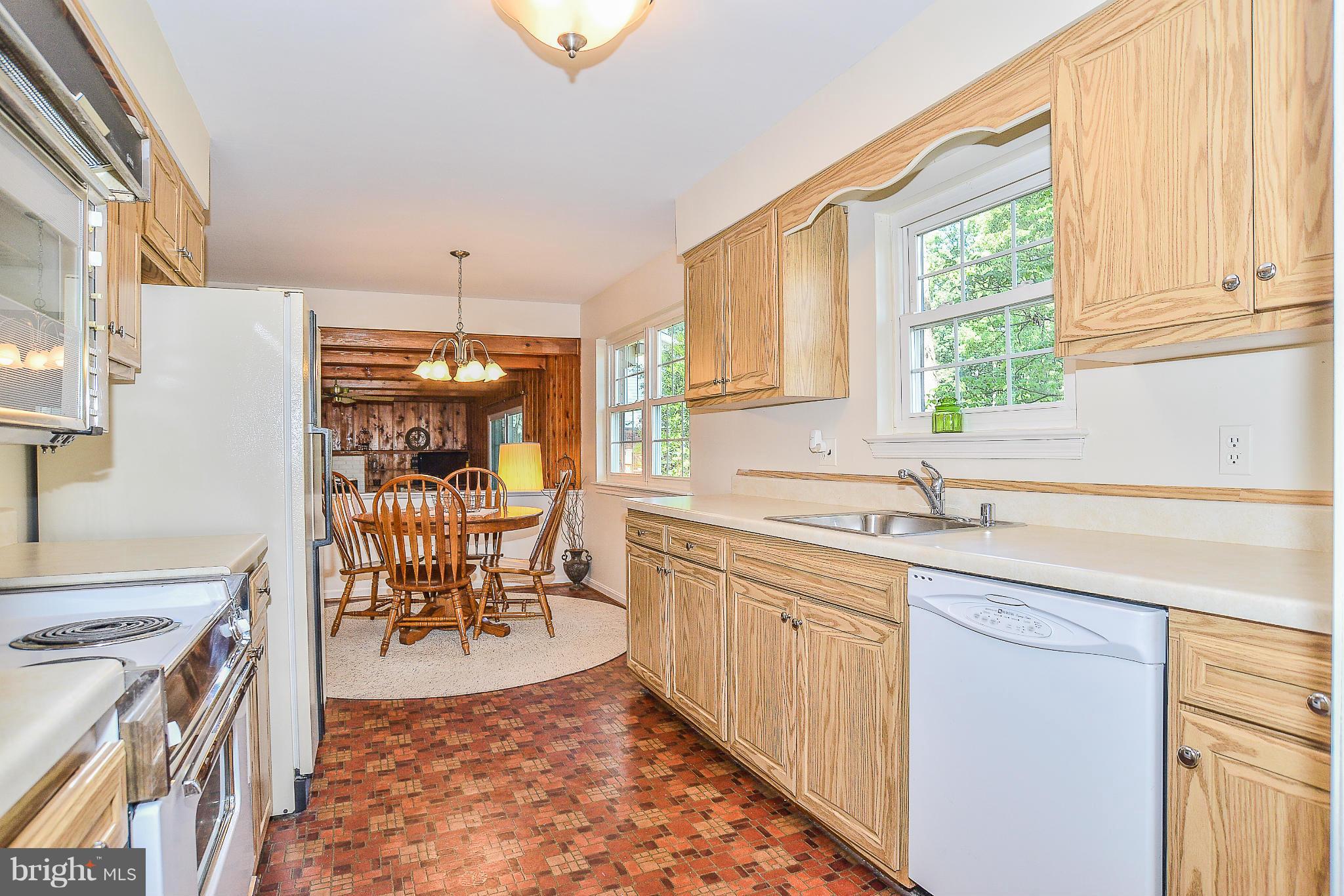 6000 Filbert Court Springfield, VA 22152 - Photo 7 of 21 a kitchen with a sink stove and cabinets