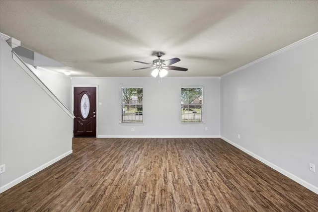 wooden floor in an empty room with a window