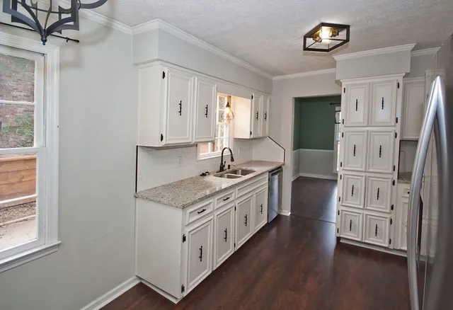 a kitchen with stainless steel appliances granite countertop a stove and a refrigerator