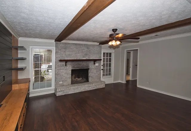 a living room with wooden floors and a fireplace