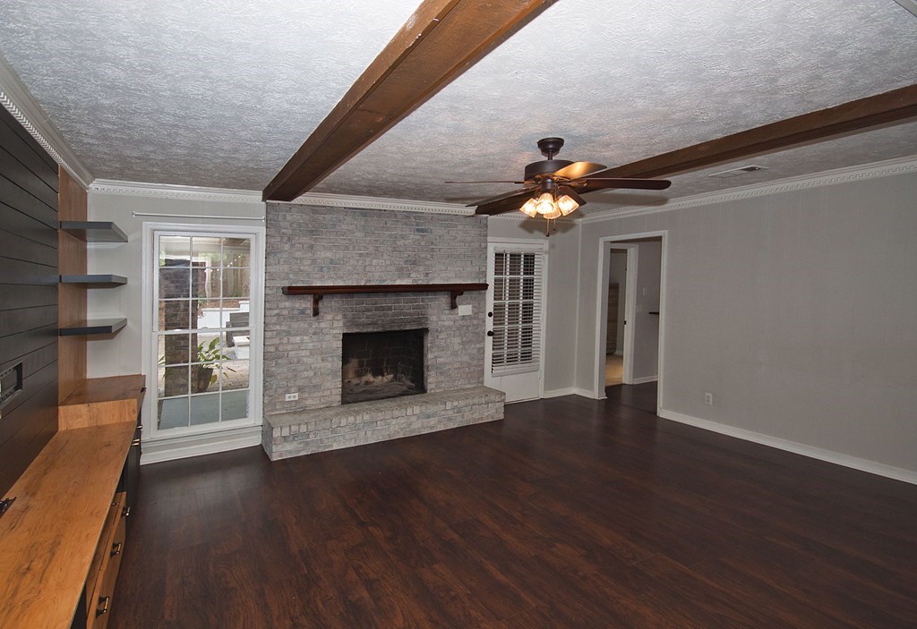6838 Buckeye Way Columbus, GA 31904 - Photo 14 of 34 a living room with wooden floors and a fireplace