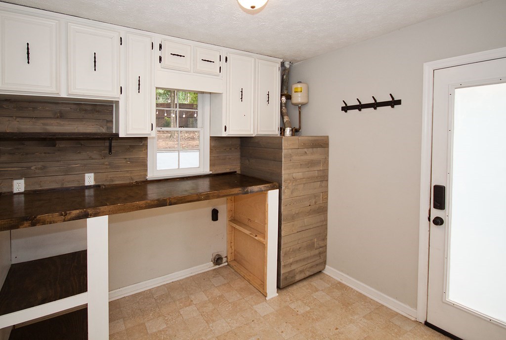 6838 Buckeye Way Columbus, GA 31904 - Photo 18 of 34 a kitchen with granite countertop a refrigerator and a sink