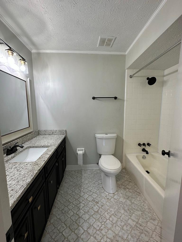 6838 Buckeye Way Columbus, GA 31904 - Photo 26 of 34 a bathroom with a granite countertop toilet sink and mirror