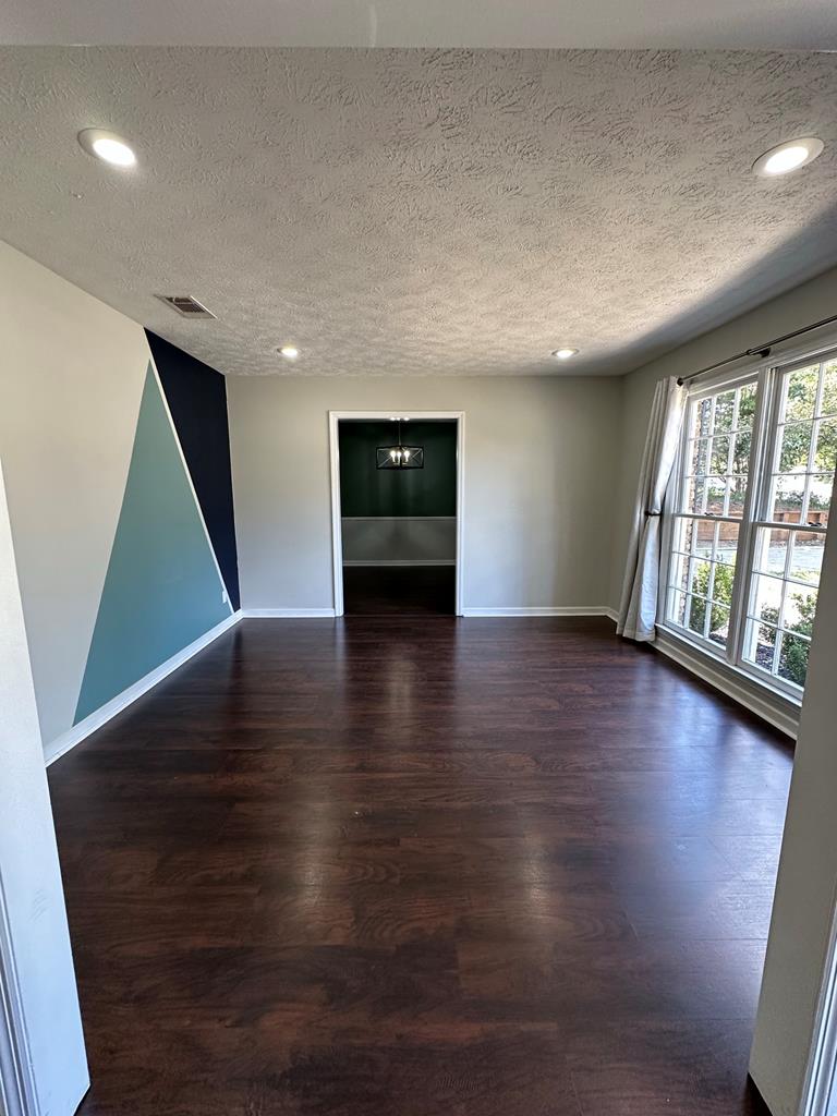 6838 Buckeye Way Columbus, GA 31904 - Photo 3 of 34 an empty room with wooden floor and windows