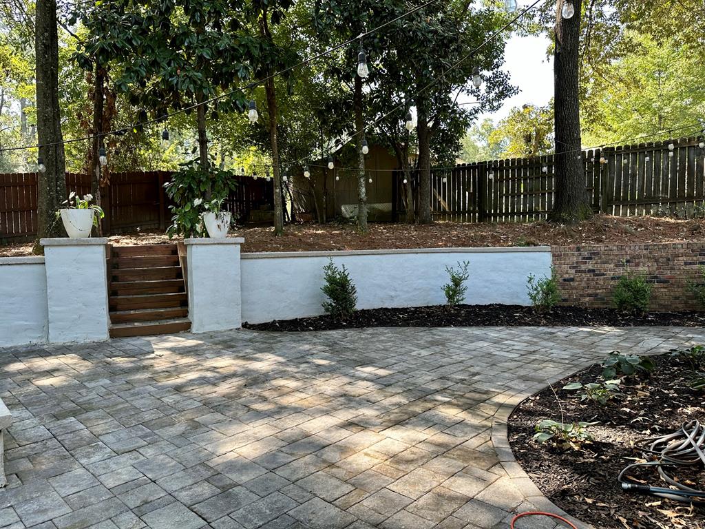 6838 Buckeye Way Columbus, GA 31904 - Photo 33 of 34 a view of a backyard with large tree and wooden fence