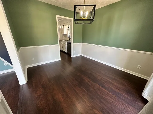 a view of a room with wooden floor and tub