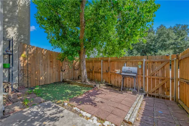 a backyard of a house with table and chairs