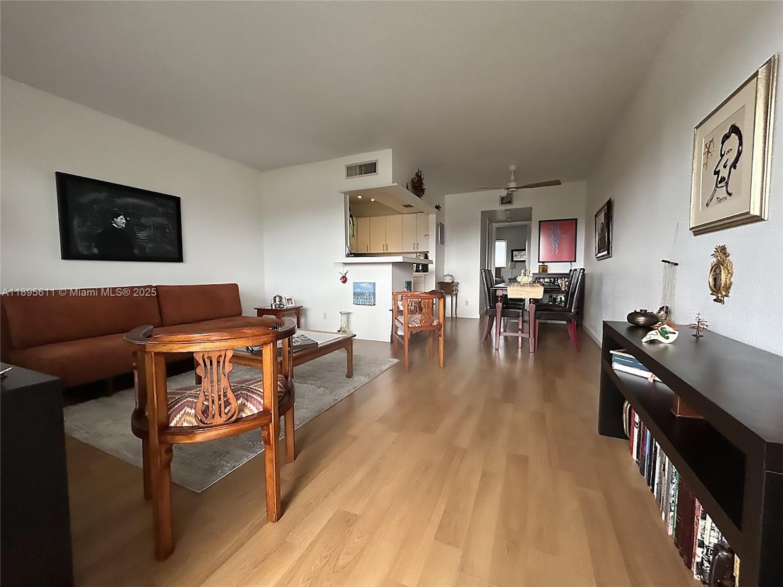 1400 Northeast 54th Street, Unit 306 Fort Lauderdale, FL 33334 - Photo 1 of 12 a living room with furniture and a flat screen tv