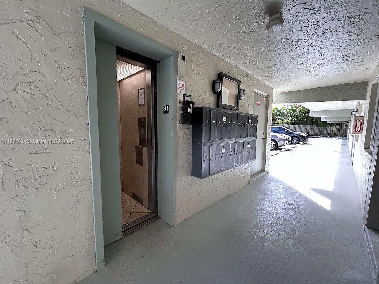 1400 Northeast 54th Street, Unit 306 Fort Lauderdale, FL 33334 - Photo 11 of 12 a view of a hallway and a livingroom with furniture