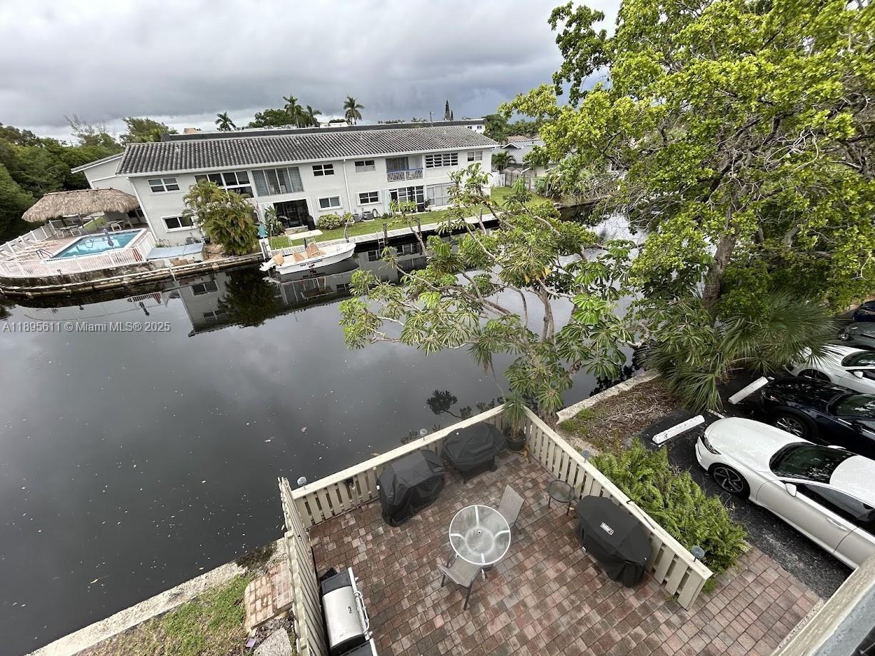 1400 Northeast 54th Street, Unit 306 Fort Lauderdale, FL 33334 - Photo 12 of 12 a view of a lake with a house