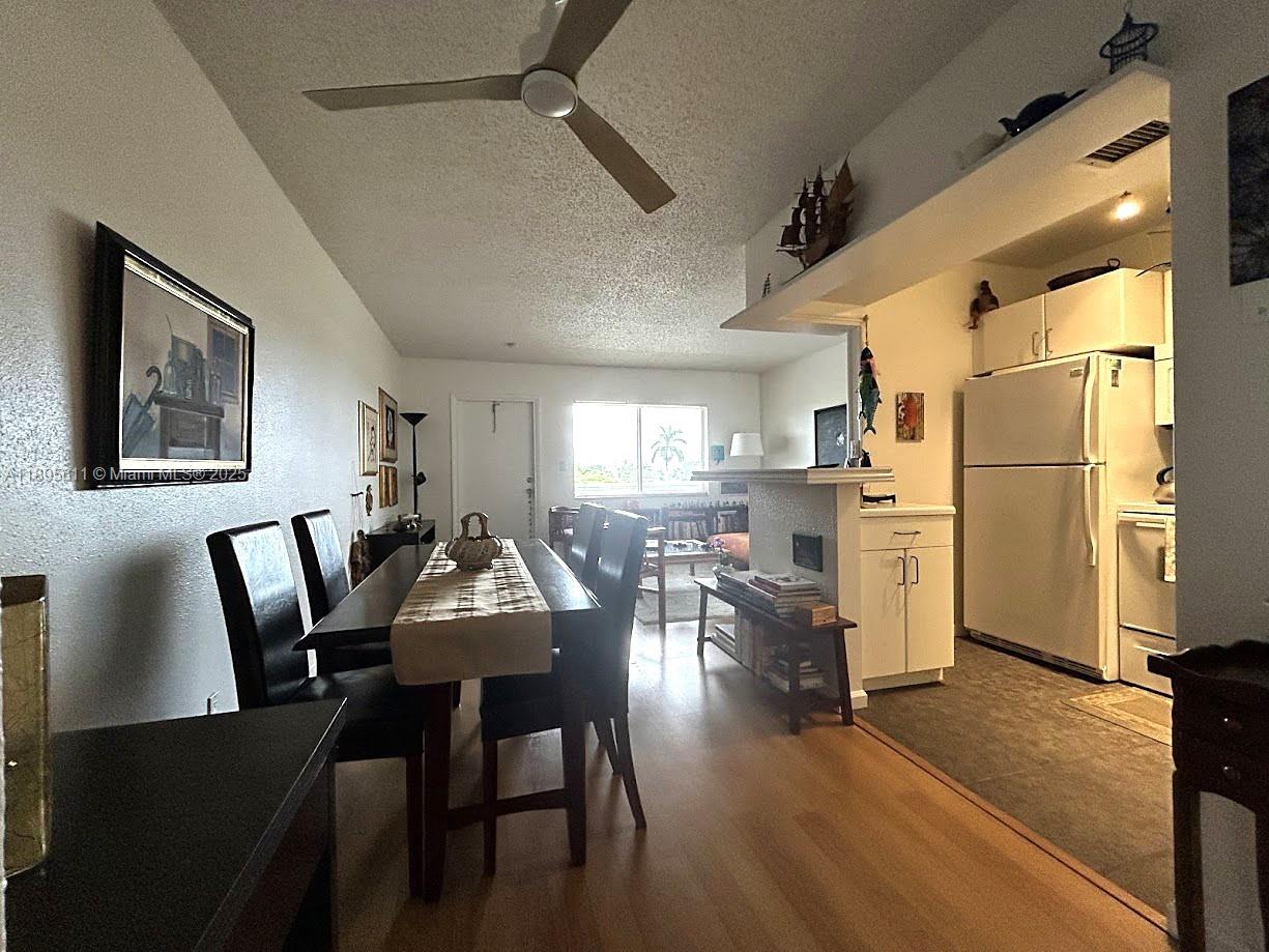 1400 Northeast 54th Street, Unit 306 Fort Lauderdale, FL 33334 - Photo 3 of 12 a dining room with furniture and wooden floor