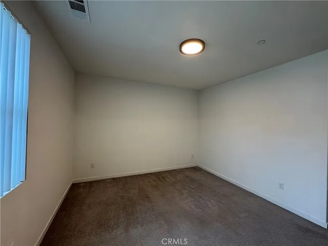 a bathroom with a granite countertop toilet sink and mirror