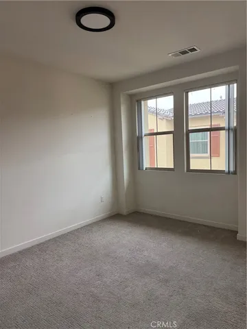 a front view of a house with a parking space