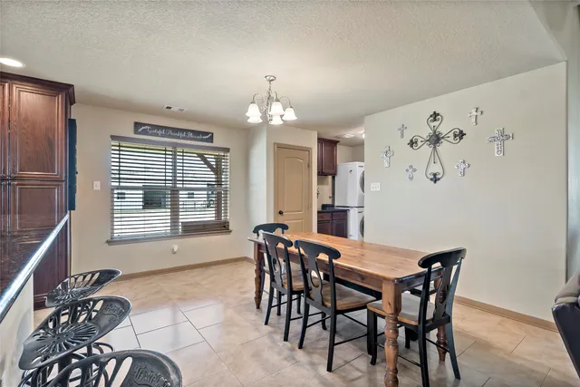 a kitchen with a table and chairs in it
