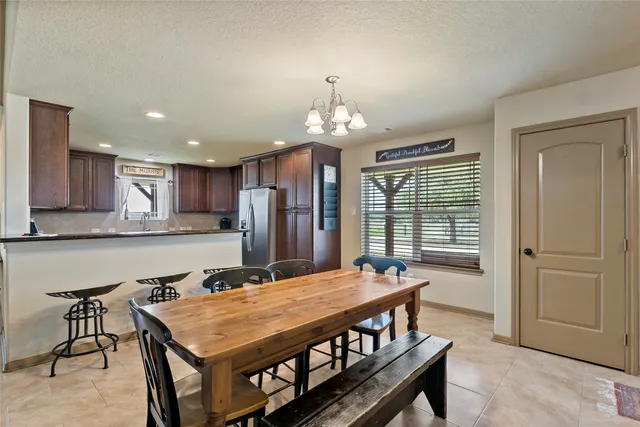 a kitchen with stainless steel appliances granite countertop a refrigerator a stove a sink and a microwave